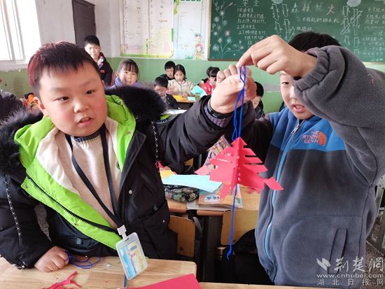 孩子們在展示自己的剪紙作品。.jpg.jpg